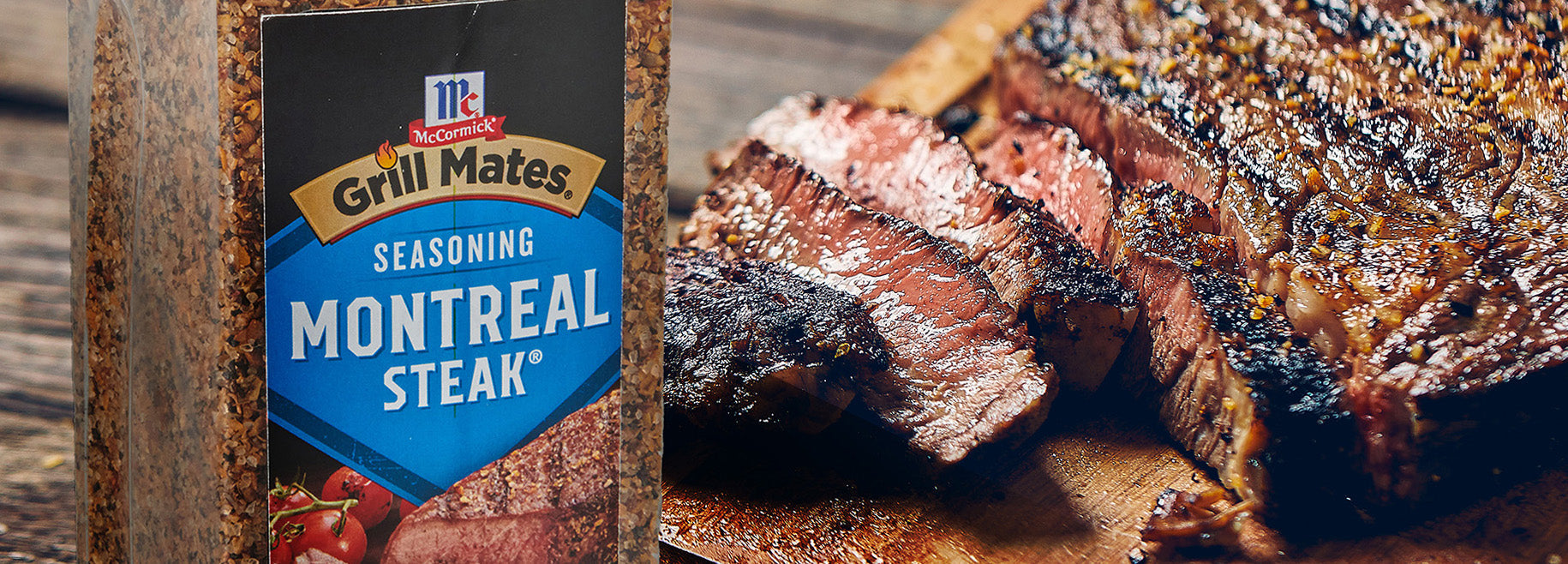 cracked black pepper & garlic with sea salt seasoning on a wooden table near a steak dish