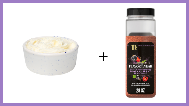 Bowl of ice cream next to a bottle of black currant flavoring on a white background