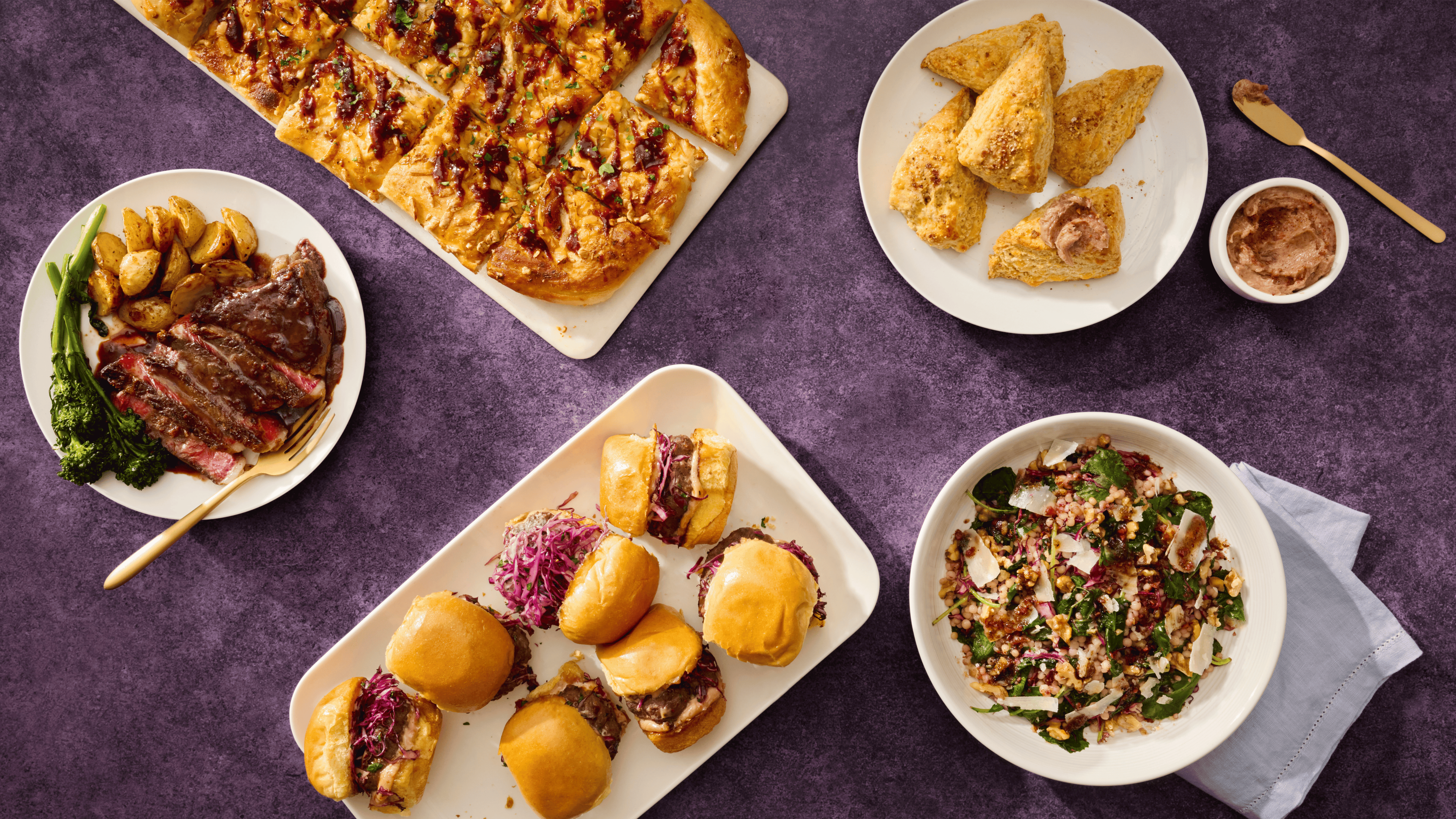 Assorted dishes including pizza, steaks, and salads on a purple background
